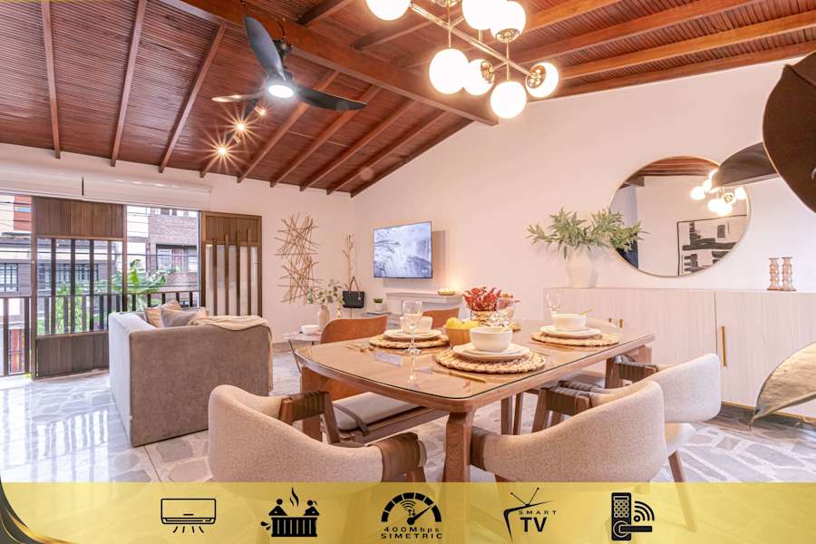 Open-concept living, dining and kitchen under a wood-beam ceiling, single level inside