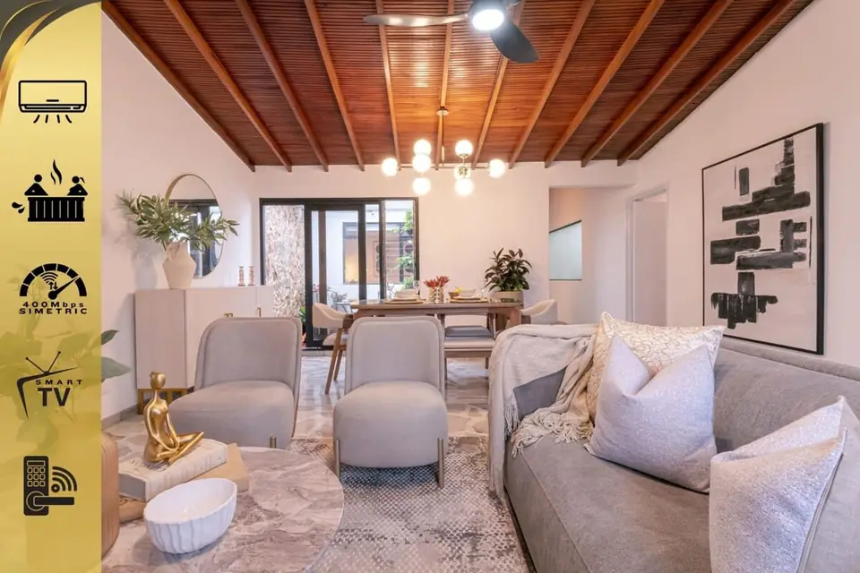 Living room with comfy sofa and 58" smart TV, opening to the terrace