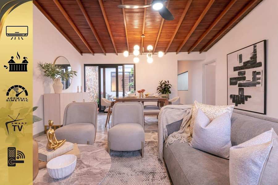 Living room with comfy sofa and 58" smart TV, opening to the terrace