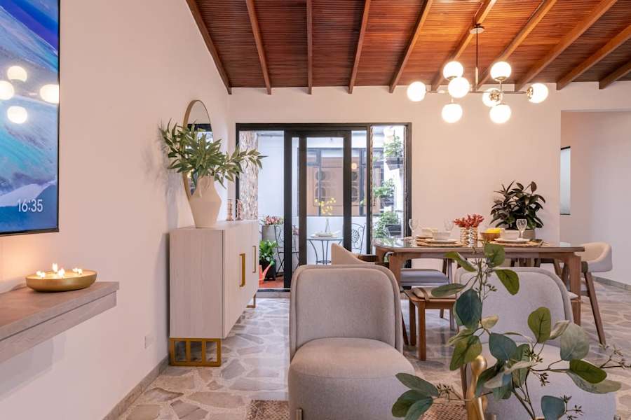 Dining area with wood-beam ceiling, ceiling fan and terrace access