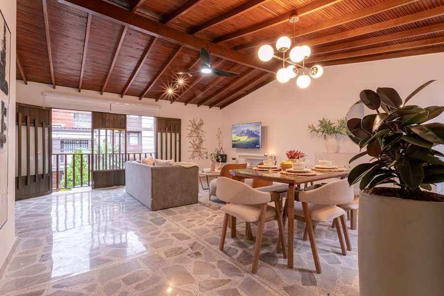 Open-plan living and dining area with kitchen island and 58" smart TV