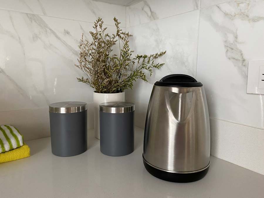 Kitchen counter with electric kettle and canisters