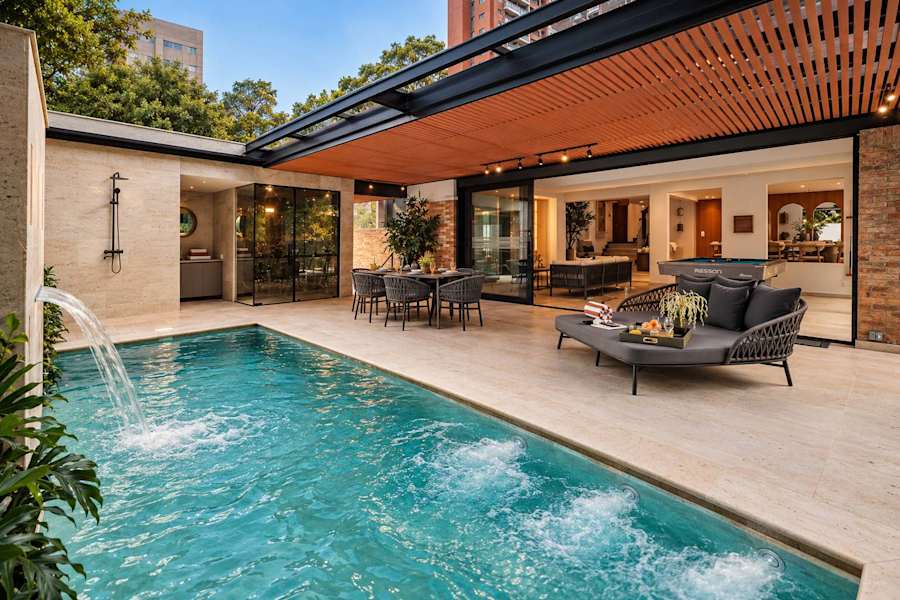Ultimate Outdoor Living. This stunning terrace features a heated pool with waterfall, glass hammam, and private rainfall shower. A seamless blend of indoor-outdoor luxury with designer dining and pool lounge for a 5-star stay.