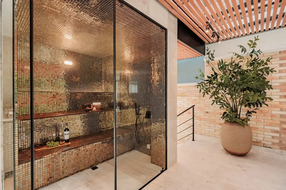 Gold-toned poolside Turkish-style steam room, designed for deep relaxation after a swim, spa moment, or quiet evening at the estate.
