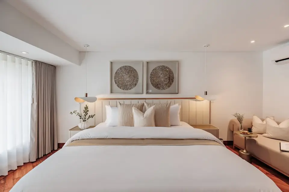 Primary Suite – Serene king bedroom with a private lounge area and elegant neutral finishes.
