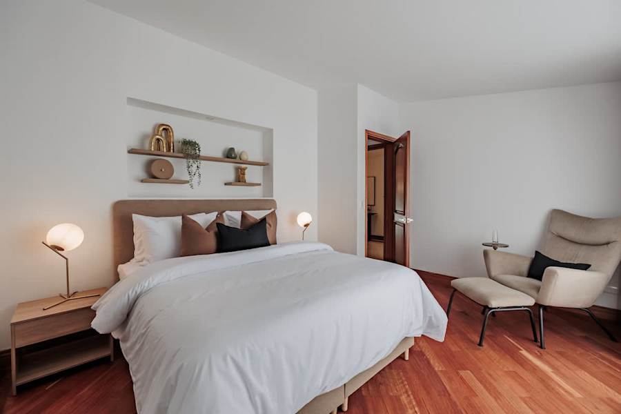 Private Suite #3: Designer Comfort. Relax in a plush queen bed surrounded by hardwood floors and artisanal decor. This climate-controlled sanctuary features a stylish reading nook and warm designer lighting for the ultimate restful experience.