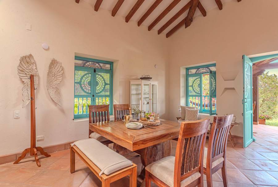 Dining for eight beside colonial carved windows