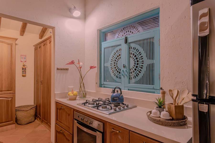 Kitchen with gas stove and carved wooden window