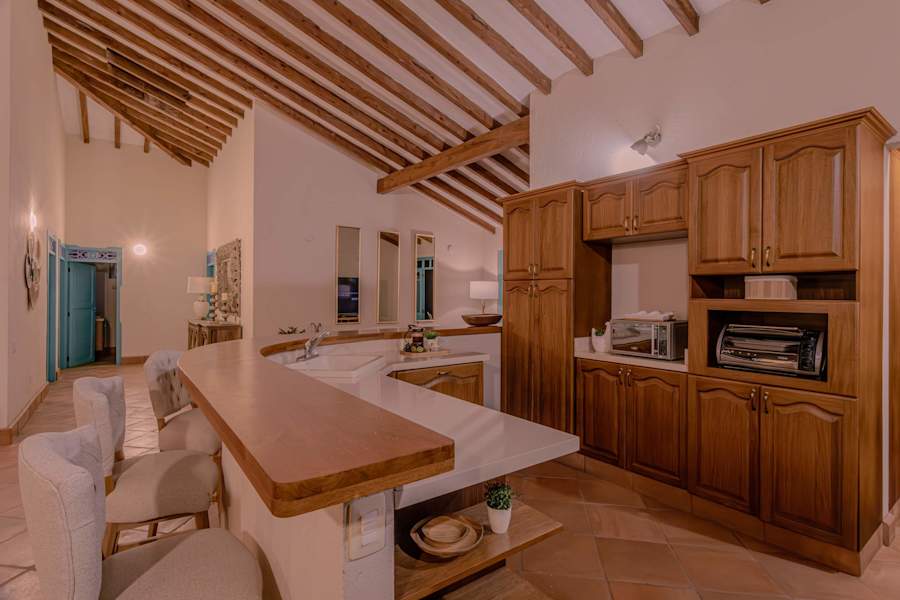 Breakfast bar and warm wood cabinetry